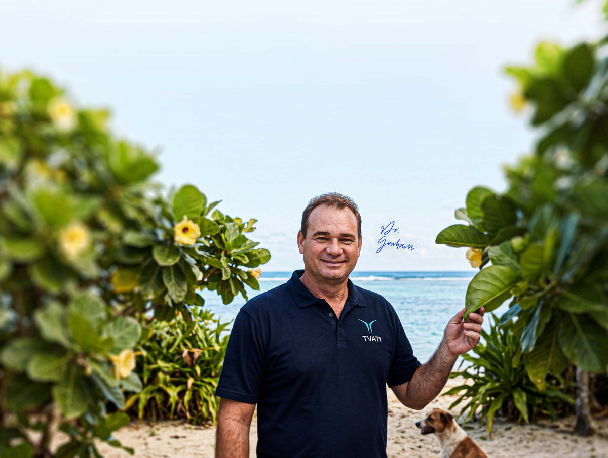 Dr Graham Matheson surrounded by hibiscus plants in the Cook Islands